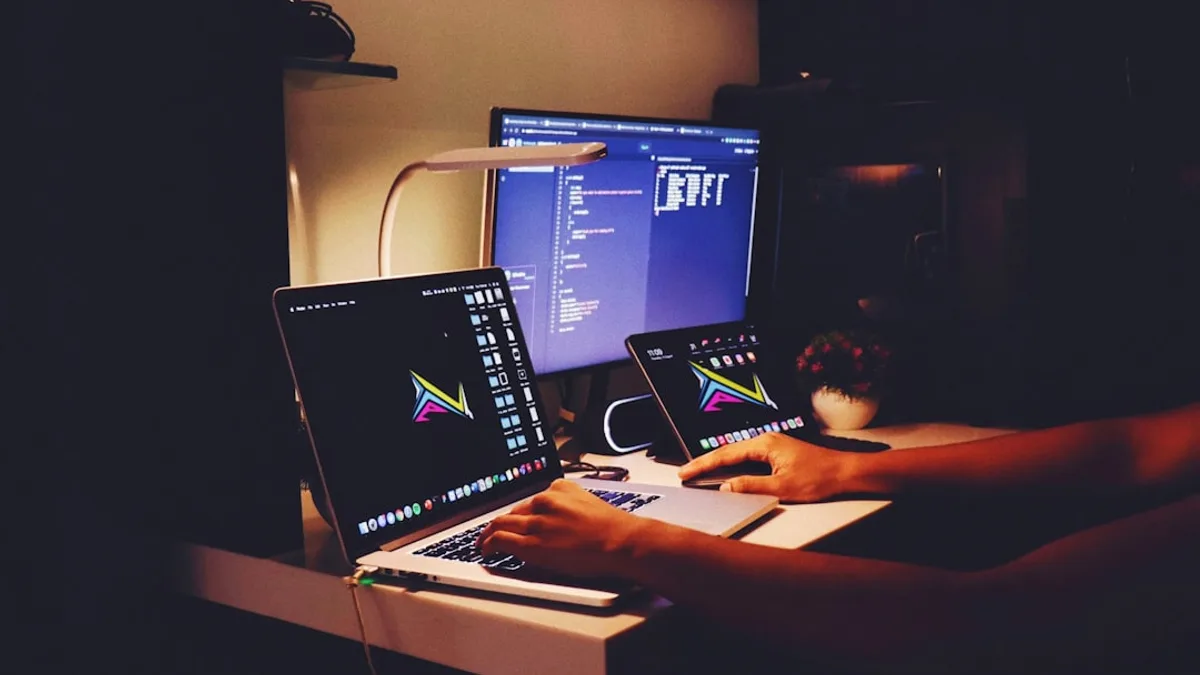 woman in black tank top sitting in front of computer
