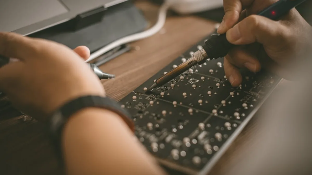 A person is typing on a laptop keyboard