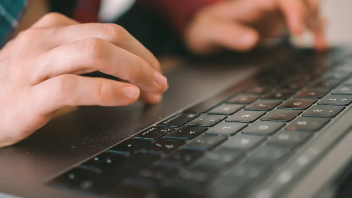persons hand on black computer keyboard