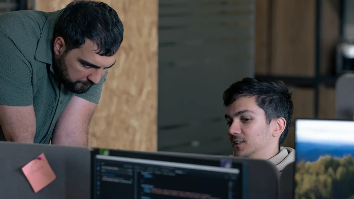 Two men working on computers in an office
