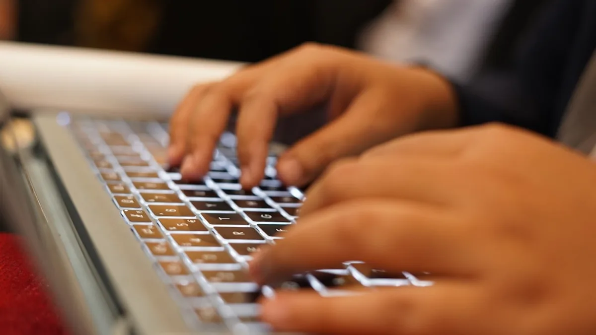 a person typing on a laptop